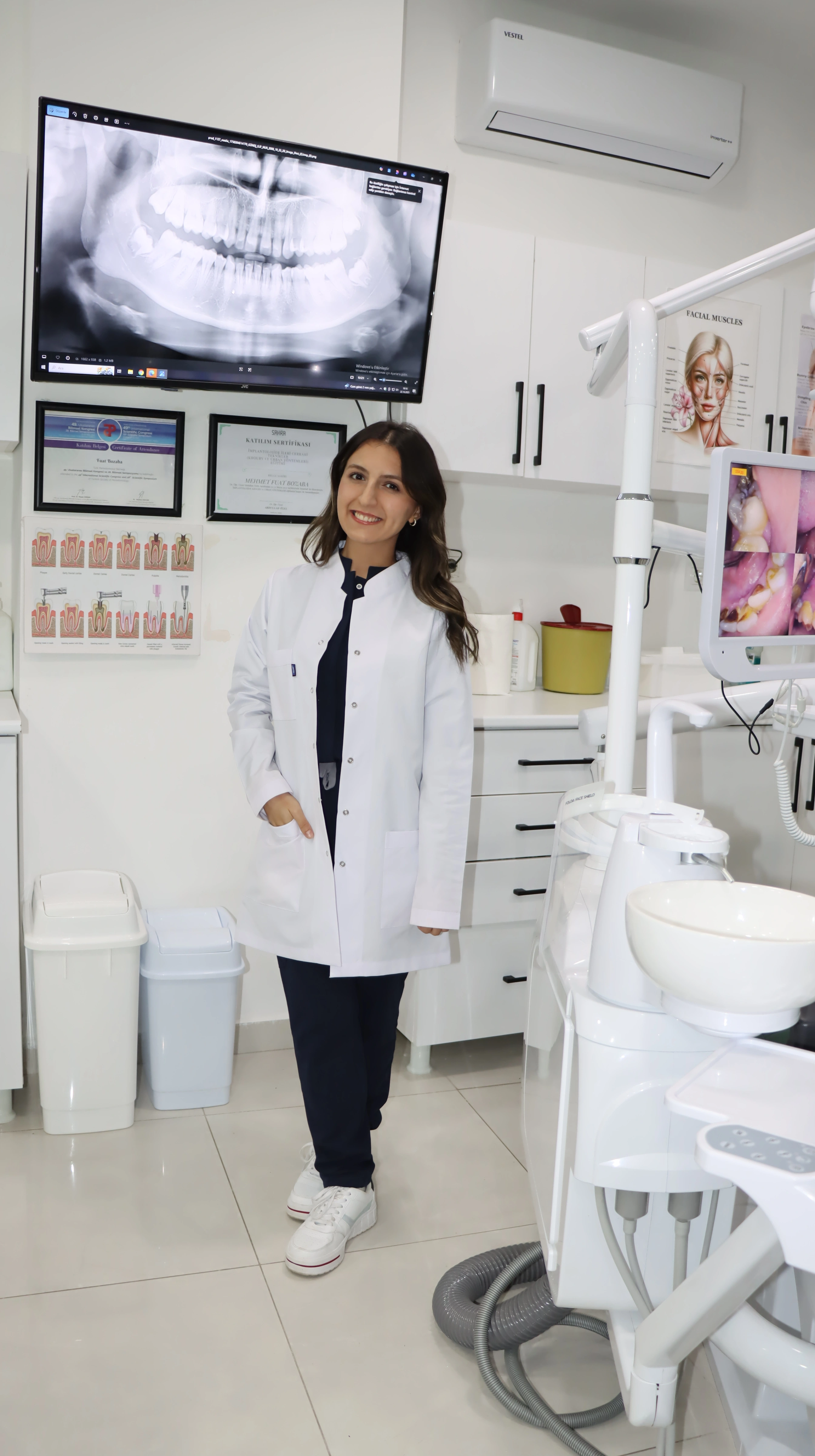Friendly pediatric dentist examining young child in modern dental clinic - Yayla Dental Akademi Istanbul